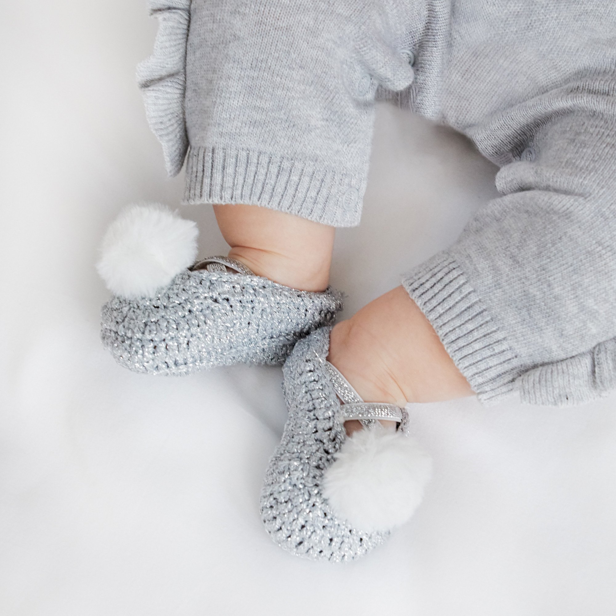 baby shoes with pom poms